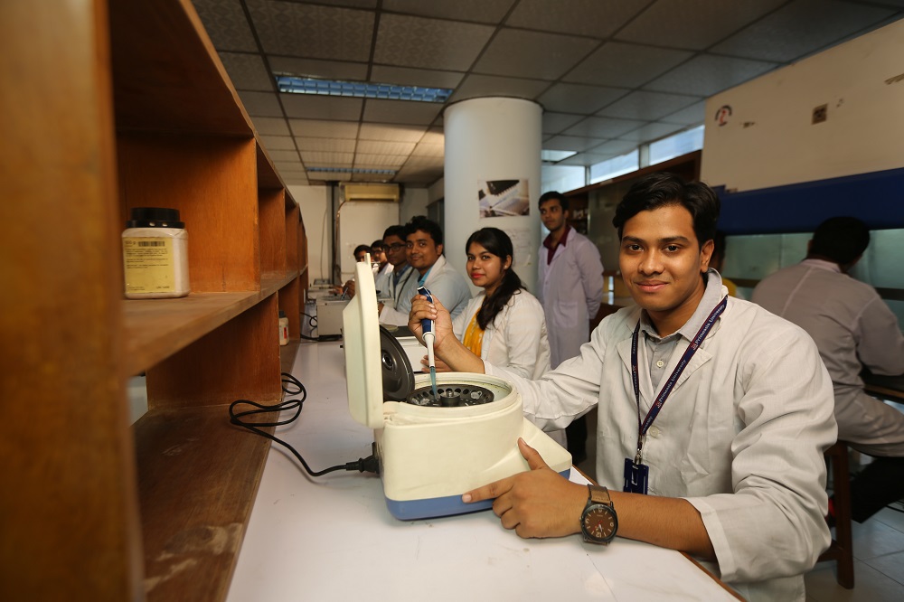 Students working with Microcentrifuge machine 2.JPG